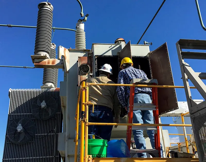 Workers are inspecting the transformer